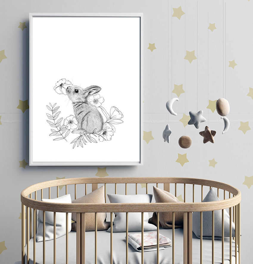 Bunny in sniffing position, surrounded by delicate line art florals and leaves